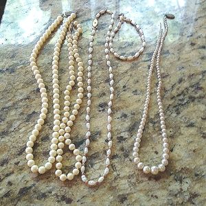 Pearl necklaces not fake white with gold in between the one.